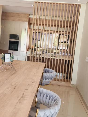 a conference room with a wooden table and chairs at Eastern Road Executive Suites in Harare