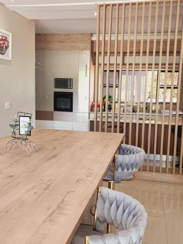 a large kitchen with a wooden table and chairs at Eastern Road Executive Suites in Harare
