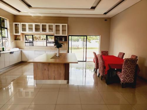 a kitchen and dining room with a table and chairs at Eastern Road Executive Suites in Harare