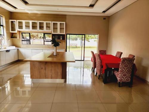 a kitchen and dining room with a table and chairs at Eastern Road Executive Suites in Harare