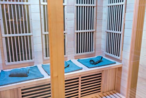 a row of prison cells with blue seats at Bath House Cabin - Hot tub, Sauna, 2 King suites in Berkeley Springs