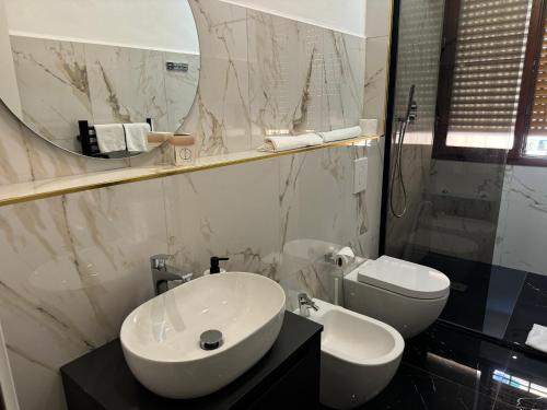 a bathroom with a sink and a toilet and a mirror at Relais Stibbert Florence in Florence