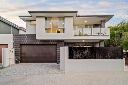 a large white house with a garage at Scarborough Escape, New 2Br Suite, 14G in Perth