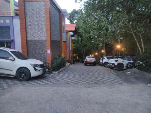 a group of parked cars parked next to a building at Sharma Jee Farm House Yercaud in Yercaud