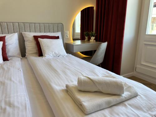 a large white bed with a towel on it at NOWE !!! Apartamenty OFF PIOTRKOWSKA w Roosevelta Residence, Klimatyzacja, Wejście na KOD, WiFi, FV in Łódź