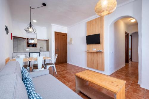 a living room with a couch and a table at Comitas Tramontana Park in Fornells