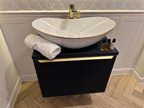 a bathroom with a bowl sink on a black vanity at NOWE !!! Apartamenty OFF PIOTRKOWSKA w Roosevelta Residence, Klimatyzacja, Wejście na KOD, WiFi, FV in Łódź