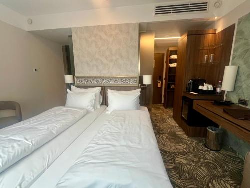 a hotel room with two beds and a desk at HOTEL CRYSTAL WELLNESS & SPA superior in Sovata