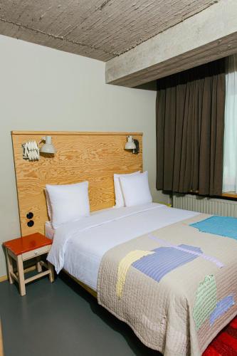 a bedroom with a large bed and a window at JAM Brussels in Brussels