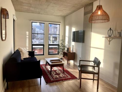 a living room with a couch and a table at Cozy apartment-Old Port Montreal in Montréal