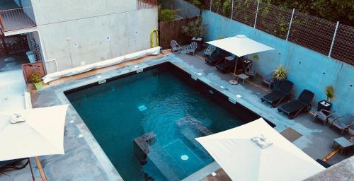 an overhead view of a swimming pool with chairs and umbrellas at Lagrange Aparthotel Montpellier Millénaire in Montpellier