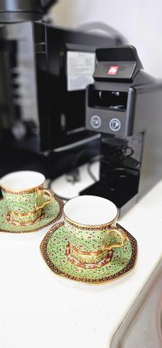 two cups on a counter next to a printer at Baan Busan - 3mins to Haeundae Beach in Busan