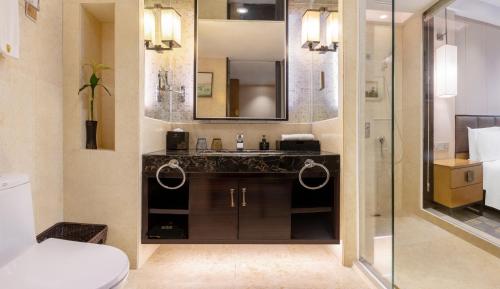 a bathroom with a sink and a mirror at Lyhn International Hotel Chengdu Taikoo Li in Chengdu