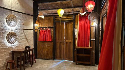 a room with two red dresses hanging on a wall at Sa Sa Lao in Luang Prabang