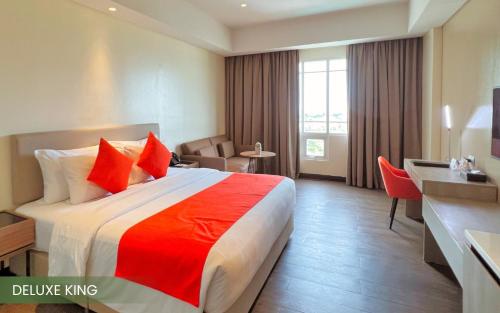 a hotel room with a bed and a desk at Acacia Hotel Davao in Davao City