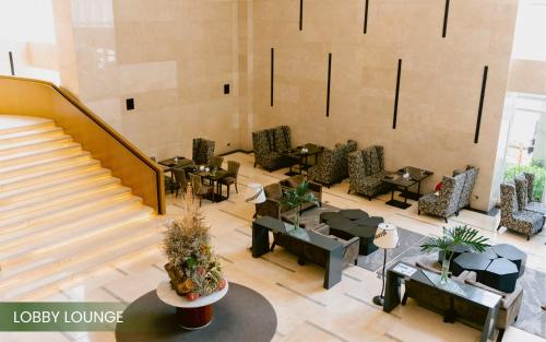 an overhead view of a lobby with tables and chairs at Acacia Hotel Davao in Davao City