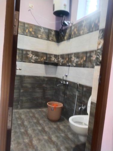 a bathroom with a shower and a toilet and a sink at Sharma Jee Farm House Yercaud in Yercaud