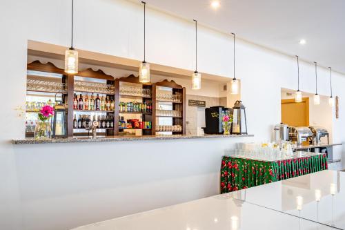 a bar at a restaurant with a counter and lights at DIUNA Beskidy - Korbielów in Korbielów