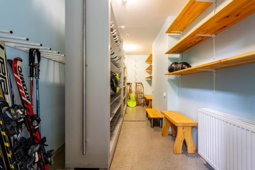 a hallway with skis and a bench in a room at DIUNA Beskidy - Korbielów in Korbielów
