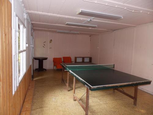 an empty room with a ping pong table in it at Srubová chata Oaza 9 in Trojanovice