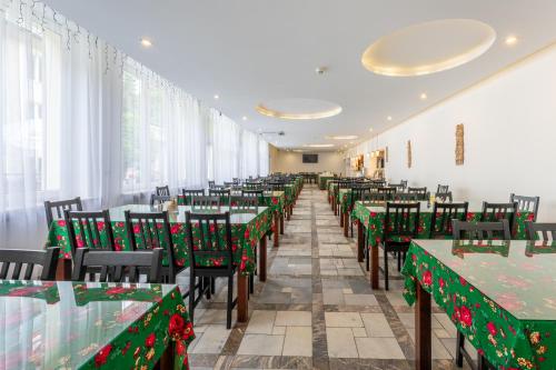 a dining room with christmas tables and chairs at DIUNA Beskidy - Korbielów in Korbielów
