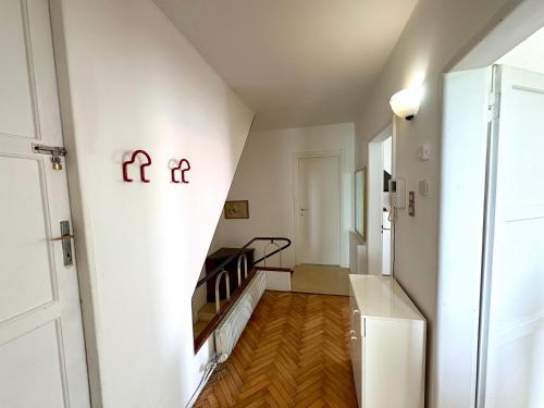 a hallway with a stairway with red signs on the wall at Chez Tosca in Treviso