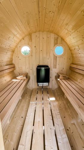 a room with a tv in a wooden cabin at Starodawna Chata - Dziad in Zamość