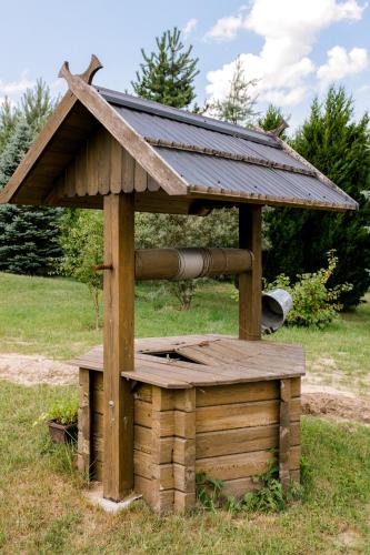 a wooden bird house with a roof on top of it at Starodawna Chata - Dziad in Zamość