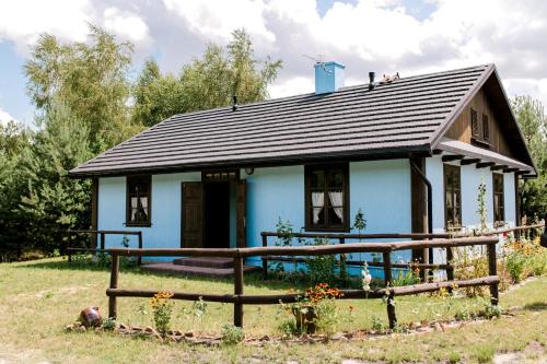 a blue house with a fence in front of it at Starodawna Chata - Dziad in Zamość