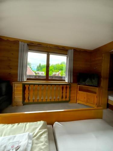 a small room with a bed and a window at Hotel Wildrose in Neukirchen am Großvenediger