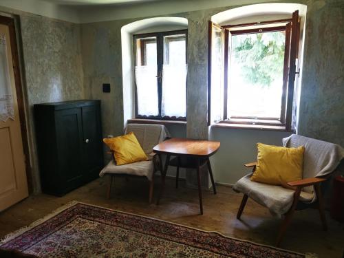 a room with two chairs and a table and a window at Ubytovanie Domček Paradajz in Banská Štiavnica