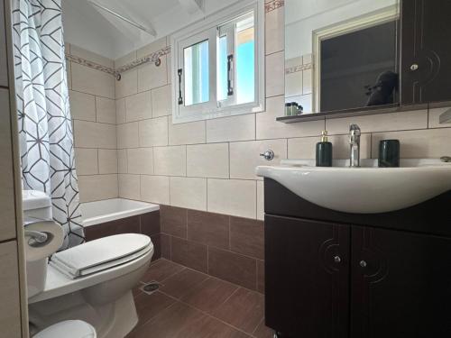 a bathroom with a sink and a toilet at Alex Apartment Suites in Virós