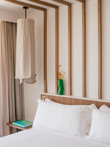 a bedroom with a white bed and a mirror at ME Marbella by Meliá in Marbella