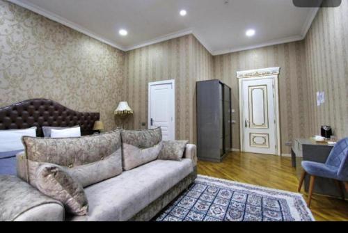 a living room with a couch and a bed at Prime Boutique Hotel in Baku