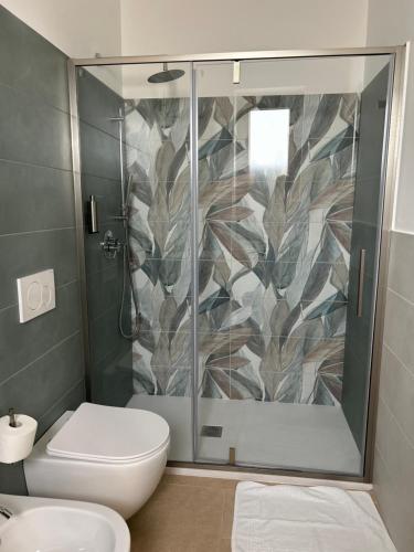 a bathroom with a shower and a toilet at Essenza Agriturismo in Putignano