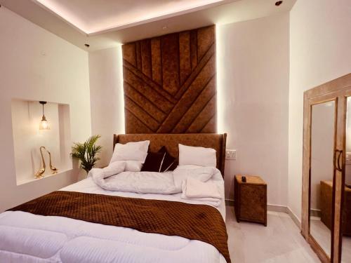 a bedroom with a large bed with towels on it at Dyson Ville in Dehradun