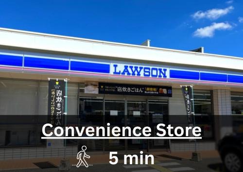 a convenience store with a sign in front of it at Transit Hostel in Izumi-Sano