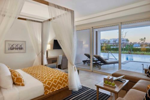 a bedroom with a bed and a living room at Steigenberger Resort Alaya Marsa Alam - Red Sea - Adults Friendly 16 Years Plus in Coraya Bay