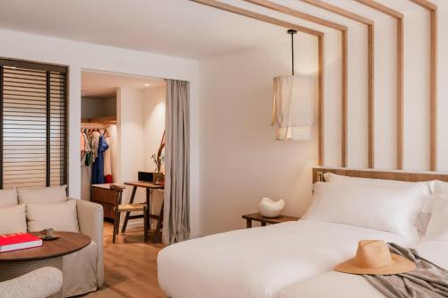 a bedroom with a white bed and a couch at ME Marbella by Meliá in Marbella