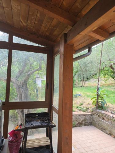 a screened in porch with a swing and a tree at B&B Camposauro in Vitulano