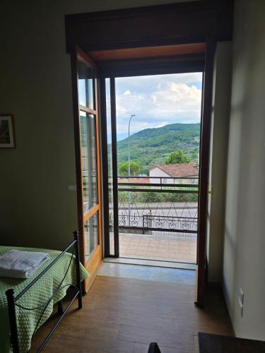 a room with a door to a balcony with a view at B&B Camposauro in Vitulano