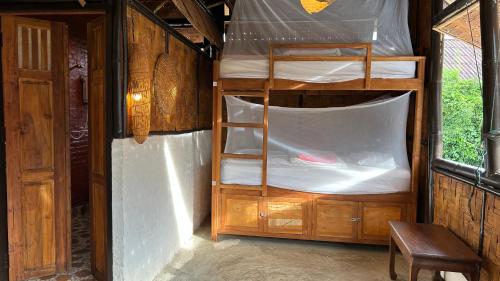 a bedroom with two bunk beds in a room at Sa Sa Lao in Luang Prabang