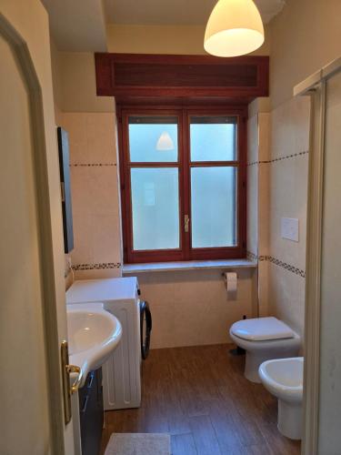 a bathroom with a sink and a toilet and a window at B&B Camposauro in Vitulano