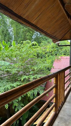 a view of a garden from a balcony at Sa Sa Lao in Luang Prabang