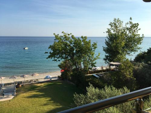 a view of the beach and the ocean from a balcony at Heavenly place in Possidi