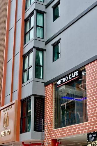 a metro cafe sign on the side of a building at Metro Hotel Phahonyothin 35 in Bangkok