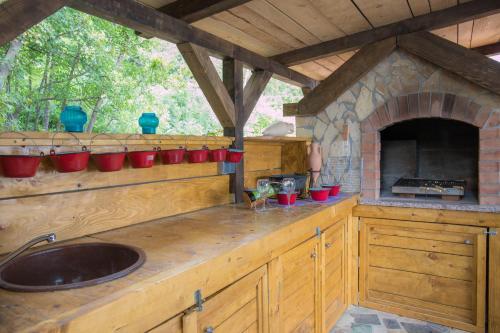 a kitchen with a sink and a brick oven at Apartman Katarina in Dramalj