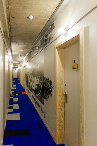 a hallway with a blue carpet and a long aisle at JAM Brussels in Brussels