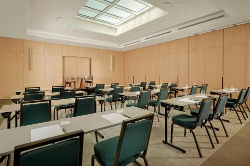 a large room with tables and chairs in it at AC Hotel by Marriott Nice in Nice