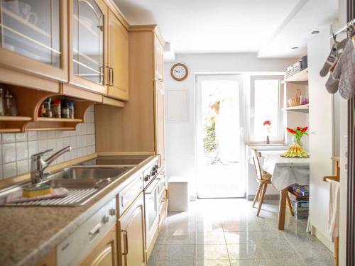 a kitchen with a sink and a table in it at Am 12er in Mittelberg